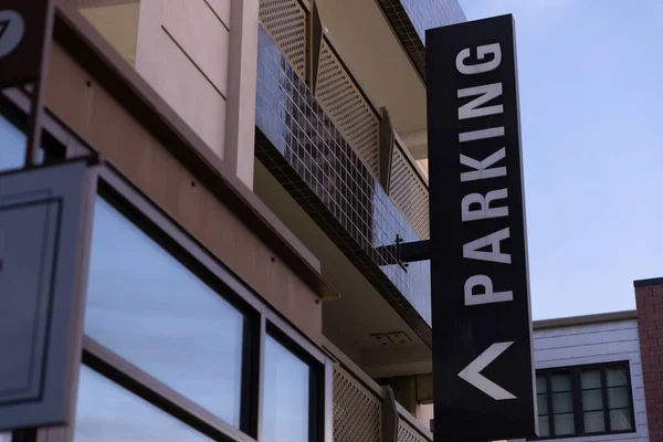 Sign for a parking lot with an arrow