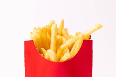 Golden french fries inside of a red container
