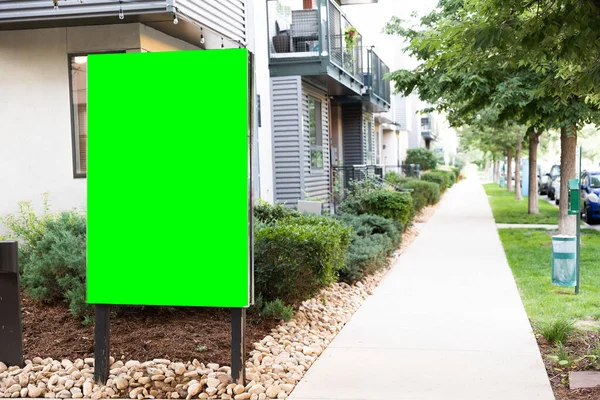 Green screen sign outside of a nice property