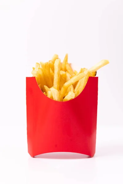 Golden french fries inside of a red container