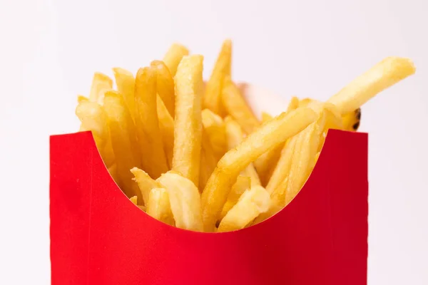 Golden french fries inside of a red container