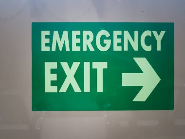 Close up of Green Emergency Exit Sign in Hospital Building