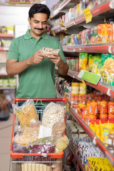 Man at grocery store products