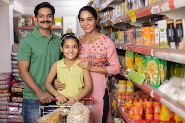 Happy family shopping for groceries at the supermarket