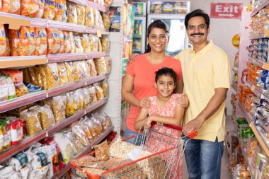 Happy family shopping for groceries at the supermarket
