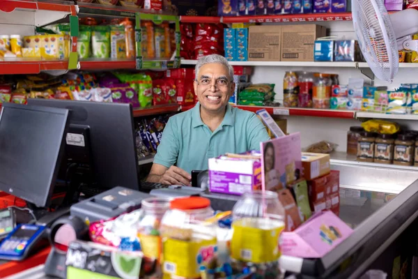 Happy man working as a cashier at supermarket