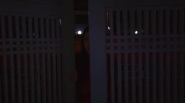 A Beautiful Chinese Woman running with happiness while wearing a red traditional Chinese dress in front of the Chinese gate