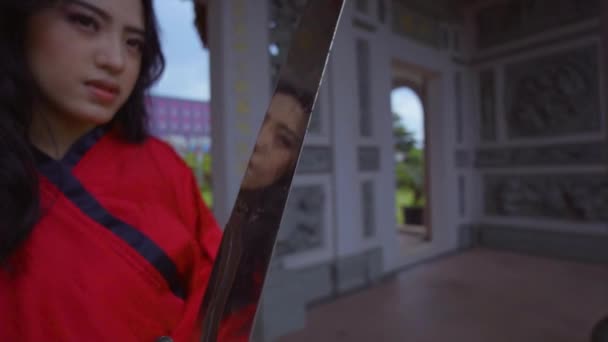 Chinese Woman Holding Silver Sword While Wearing Red Traditional Chinese — Stockvideo