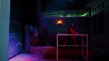 Asian Women Dancing on the top of the table lonely with angry feelings inside herself in the night