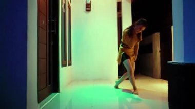 Asian women dancing on the terrace floor in front of the house at the night