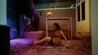 Poor Asian Woman dancing with the table by holding and hitting it with anger in the night