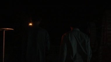 A Muslim boy walking in the night while holding the fire torch only to light the way from the flame