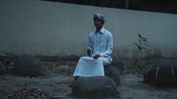 Muslim Boy Sitting Rock While Wearing White Praying Clothes Morning — Stock videók