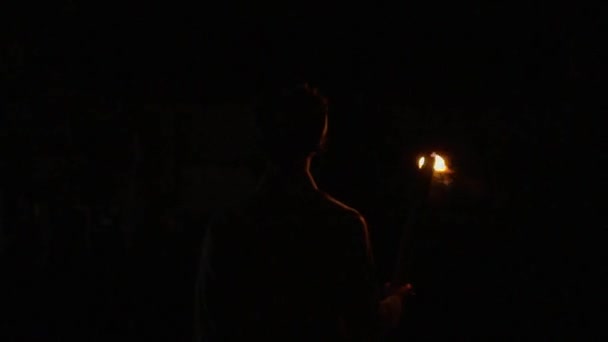 Muslim Boy Walking Night While Holding Fire Torch Only Light — Stockvideo