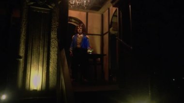A Human in a Beast costume standing in front of the table at the palace inside the castle