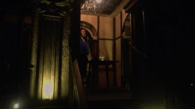 A Human in a Beast costume standing in front of the table at the palace inside the castle