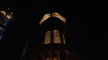 Beautiful palace in the dark night with the warm lighting and a huge tower inside the castle