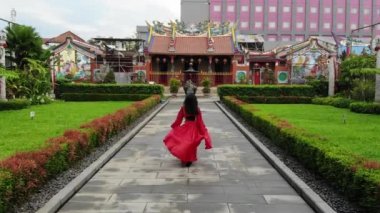 Aerial shoot of Asian woman training her skill in martial arts inside the temple at China town