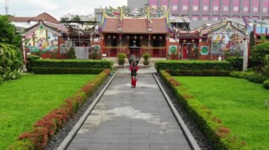 Aerial shoot of Asian woman training her skill in martial arts inside the temple at China town