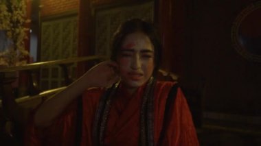A Chinese woman gets bullying by her friends and cries lonely with clown make-up in the dark night
