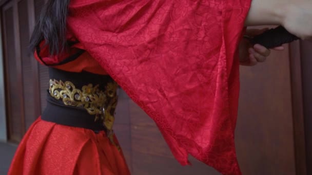 Asian Woman Training Her Sword While Wearing Red Dress Battle — Stock videók