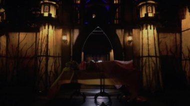 A Princess sleeping on her outdoor bed in front of the castle inside her palace during the dark night