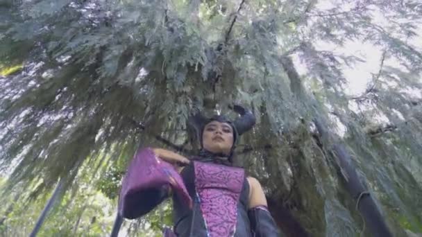 Asian Woman Black Horn Purple Costume Standing Tree Mysterious Face — Stock Video