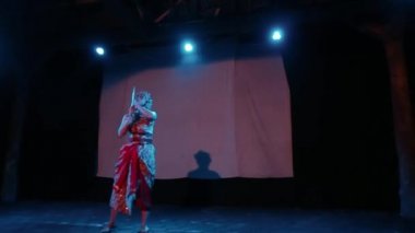 Bir Java dansçısı kendi vücudunun sahne ışığında dans ederken vücudunu ritme göre hareket ettirir.