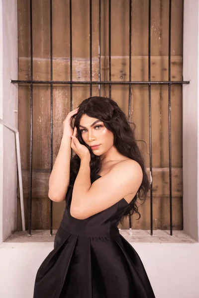 Portrait of an Asian woman with black hair being lonely with the wooden window in the background