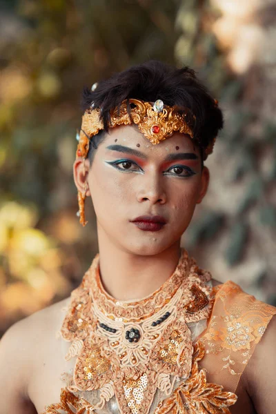 在巴厘岛海滩附近化妆时 一个戴着金色头饰和金项链的性感亚洲男人 — 图库照片