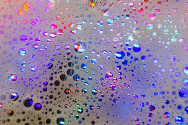 Soap foam. Background of dusty foam with bubbles of blue color for an inscription. Abstract multicolored, white, red, blue background. Colored soap foam texture. Shampoo foam with bubbles.
