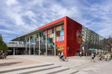 Big red building called Plopsa Station, a childrens theme park from Plopsaland at mediaplein trainstation in Antwerp