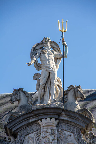 Statue of Poseidon in the city of Ghent with blue background