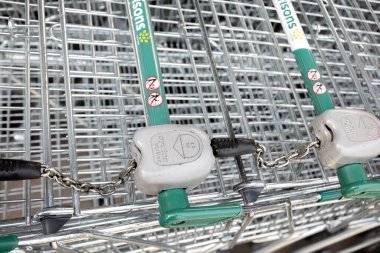 Closeup of Supermarket shopping trolleys locking system at Morrisons supermarket