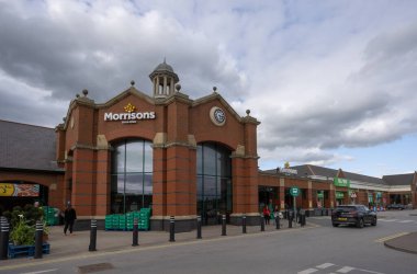 Entrance of Morrisons supermarket Starbeck store with clouds behind