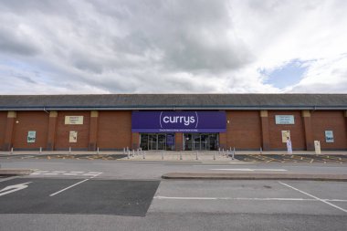 Frontage, logo and car park of British electronics retailer, Currys in Harrogate