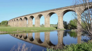 Beautiful reflection of Arthington viaduct near Otley in the water on a blue clear day