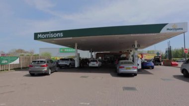 People in vehicles waiting for fuelling at Morrisons petrol station in UK