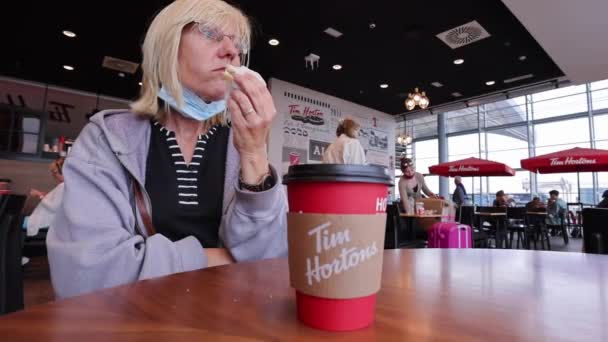 Blonde Woman Wearing Glasses Eating Ham Sandwich Tim Horton Cafe — Stockvideo