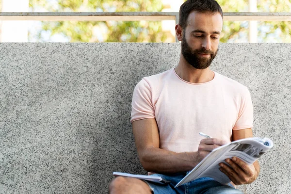 Serious Bearded Latin Man Reading Announcement Searching Job Sitting Street — Foto Stock