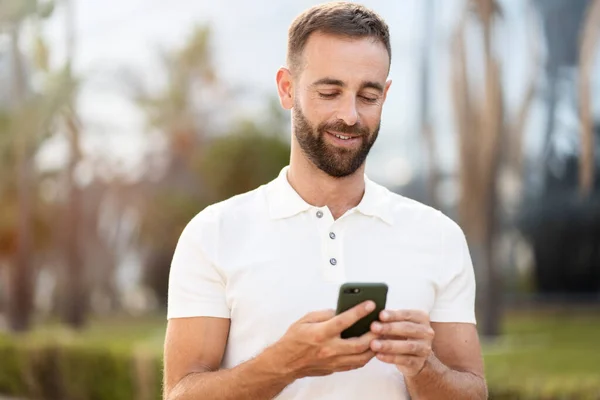 Smiling Handsome Latin Man Using Mobile App Shopping Online Street — Stock fotografie