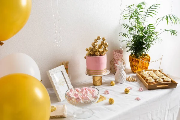 Tavolo festivo con torta e palloncini. Decorazione rosa e oro Immagini Stock Royalty Free