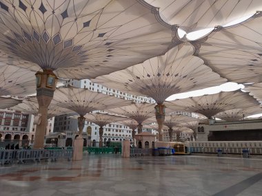 Medine, Suudi Arabistan - 07 Ekim 2022: El-Mescid An-Nabawi veya Peygamber Muhammed Camii meydanında Şemsiye inşaatı insanları gündüzleri güneşten koruyor ve geceleri aydınlık olarak çalışıyor