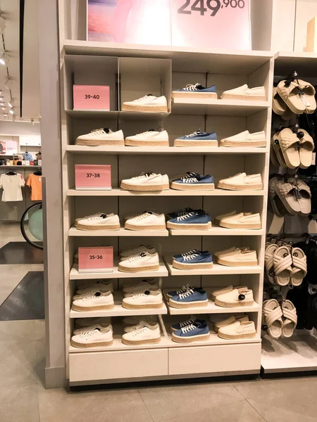 display of men's and women's shoes for sale at modern mall