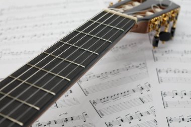Guitar, musical instruments on sheet music.
