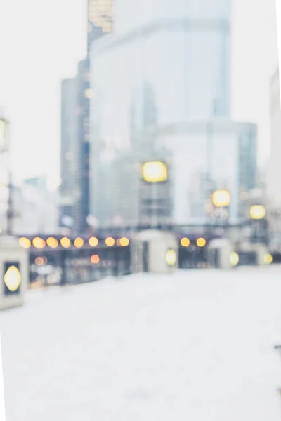 Intentionally blurred Chicago city view in winter with snow and bokeh lights background