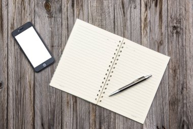 Blank note book on wood texture background.