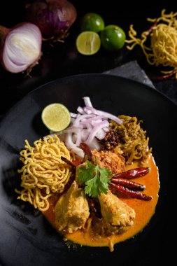 Khao Soi Recipe,Khao Soi,Khao Soi Kai, Thai Noodles Khao Soi, Chicken Curry with seasoning on wooden floor, Northern Thai food concept. (Lanna food)