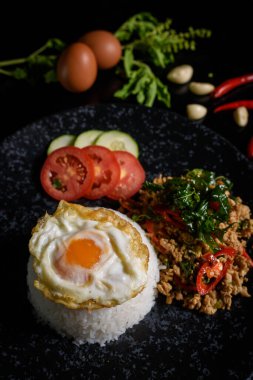 Thai Food Rice topped with egg and stir-fried beef and basil, famous street food in Thailand, fast food, soft focus