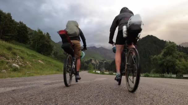 Two mountain bikers riding on bikes bikepacking style — Stock Video